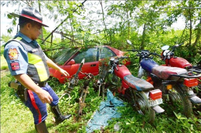 Police Executive Master Sergeant Pedro Pericon, officer in charge of the Provincial Highway Patrol Team-Iloilo, checks a carnapped automobile and motorcycles that his unit impounded at their headquarters in Barangay Balabago, Jaro, Iloilo City. Their impounding area badly needs improvement. IAN PAUL CORDERO/PN