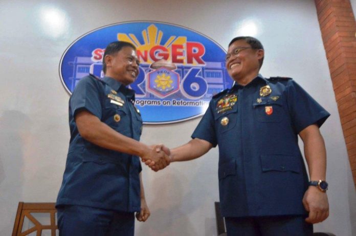 LAW ENFORCERS. Controversial Police Lieutenant Colonel Jovie Espenido (left) is welcomed to the Police Regional Office 6 by Brigadier General Rene Pamuspusan, Western Visayas police director. Espenido has been designated deputy city director for operations of the Bacolod City Police Office. His main task is to run after drug traffickers. IAN PAUL CORDERO/PN