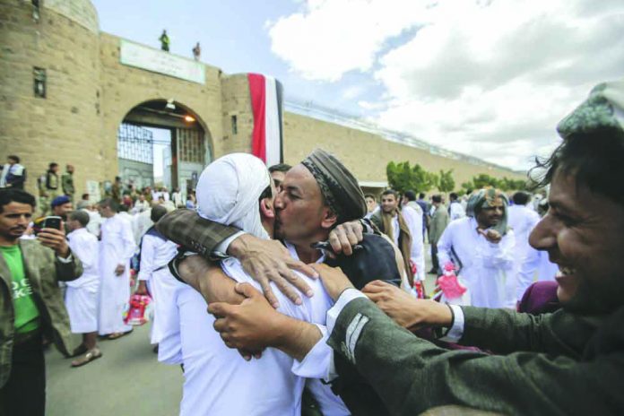 A Yemeni detainee is greeted by his relative and friends after his release from a prison controlled by Houthi rebels, in Sanaa, Yemen on Sept. 30, 2019. AP