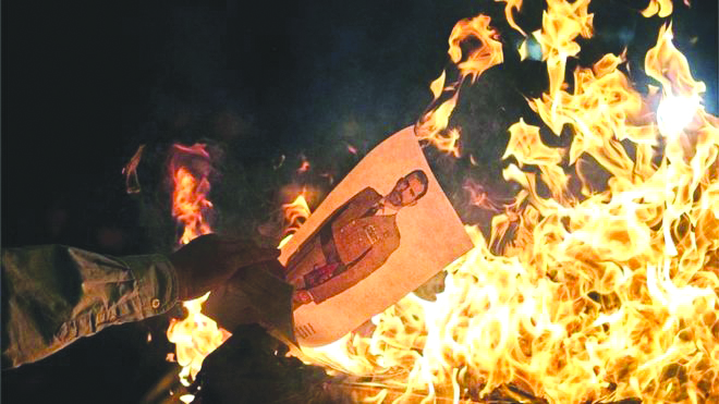 Separatist protesters burned pictures of Spain's King Felipe VI. EPA