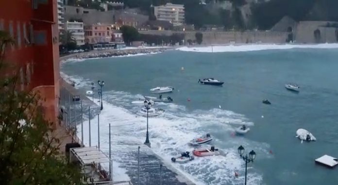 Waves flood the street in Villefranche-Sur-Mer, France on Nov. 23 in this still image obtained from a social media video. BRICE RODIERE/VIA REUTERS