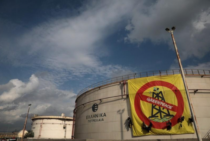 Greenpeace activists hang from an oil tank at the Hellenic Petroleum refineries in Aspropyrgos near Athens, Greece, on Nov. 21. COSTAS BALTAS/REUTERS