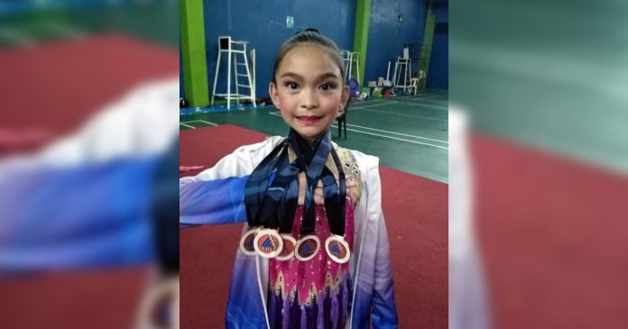 Gymnast Matthea Given Efenio shows the medals she won for – Bacolod Tay Tung High School during the 39th NOPSSCEA.