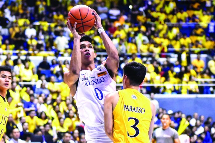 Ilonggo Ferdinand “Thirdy” Ravena III of Ateneo Blue Eagles goes for a basket against University of Santo Tomas Growling Tigers’ Brent Paraiso. UAAP PHOTO