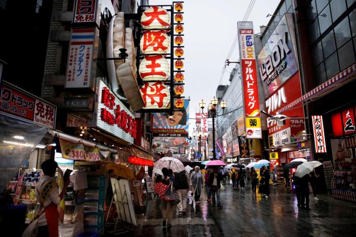 People walk through a shopping district in Osaka, western Japan. Japan’s retail sales tumbled in October due to sales tax hike that prompted consumers to cut spending, raising a red flag over the strength of domestic demand. THOMAS WHITE/REUTERS