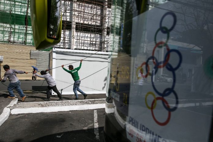 Workers tug on telecommunication cables near the Philippine Wushu Building which is ongoing construction near the Rizal Memorial Coliseum in Manila in Nov. 27, 2019. ABS-CBN NEWS