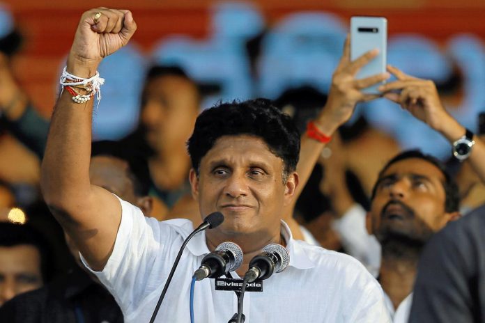 Sajith Premadasa, Housing Minister and the presidential candidate of the United National Party, gestures at his supporters during his first election campaign rally in Colombo, Sri Lanka on Oct. 10. REUTERS/DINUKA LIYANAWATTE