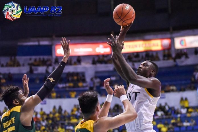 University of Santo Tomas Growling Tigers’ Soulemane Chabi Yo scores against two Far Eastern University Tamaraws defenders. UAAP PHOTO