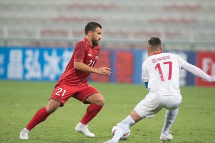 A Syrian player tries to dribble the ball past Stephen Schrock of the Philippine Azkals in their second round matc up in the joint 2022 FIFA World Cup and 2023 Asian Cup Qualifiers held in Dubai on Tuesday. AFC