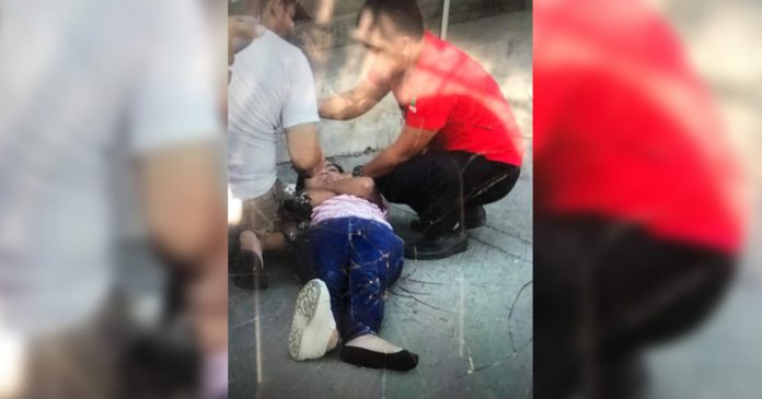 A young woman’s attempt to kill herself by jumping from the second floor of a parking building on Ledesma Street, Iloilo City failed. These men came rushing to help her after her fall yesterday morning, Nov. 21, 2019. IAN PAUL CORDERO/PN