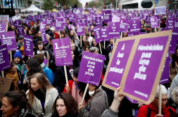 Demonstrators carry signs to protest “femicide” and violence against women in Paris, France on Nov. 23. REUTERS/CHRISTIAN HARTMANN