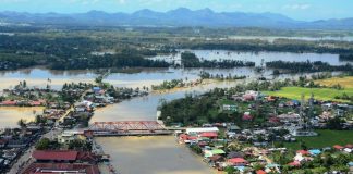 PAN-AY RIVER BURSTS. This aerial shot of Pontevedra, Capiz shows the Pan-ay River overflowing, its murky water engulfing residential and commercial areas of the municipality, and turning vast rice fields into instant rivers as well. Other towns in Capiz also reported flooding, prompting the provincial government to declare a state of calamity. IAN PAUL CORDERO/PN