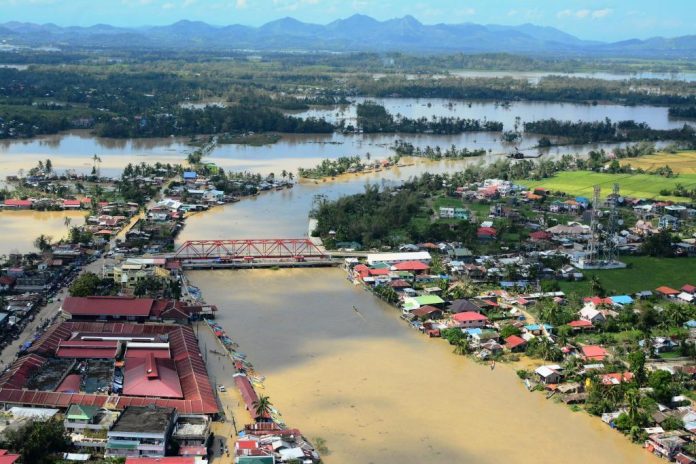 PAN-AY RIVER BURSTS. This aerial shot of Pontevedra, Capiz shows the Pan-ay River overflowing, its murky water engulfing residential and commercial areas of the municipality, and turning vast rice fields into instant rivers as well. Other towns in Capiz also reported flooding, prompting the provincial government to declare a state of calamity. IAN PAUL CORDERO/PN