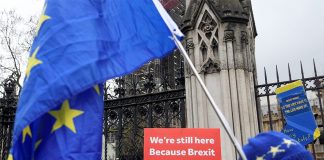 Anti-Brexit demonstrators hold signs outside the Houses of Parliament in London, Britain, Dec. 17, 2019. REUTERS