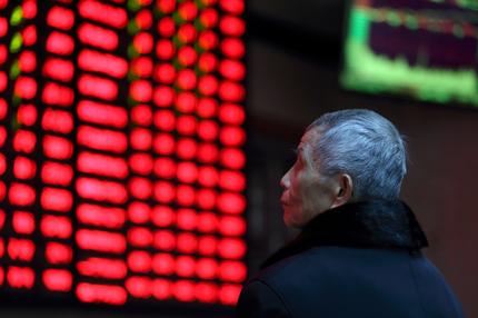 A man looks at an electronic board showing stock information at a brokerage house in Nanjing, Jiangsu province, China. REUTERS