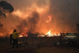 Rural Fire Service crews engage in property protection of a number of homes along the Old Hume Highway near the town of Tahmoor as the Green Wattle Creek Fire threatens a number of communities in the southwest of Sydney, Australia on Dec. 19. AAP IMAGE/DEAN LEWINS/VIA REUTERS