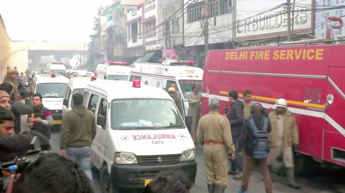 Ambulances and a firefighting vehicle responded at the scene of a deadly fire that swept through a factory where laborers were sleeping, in New Delhi, India on Dec. 8, in this still image taken from a video. ANI/VIA REUTERS TV