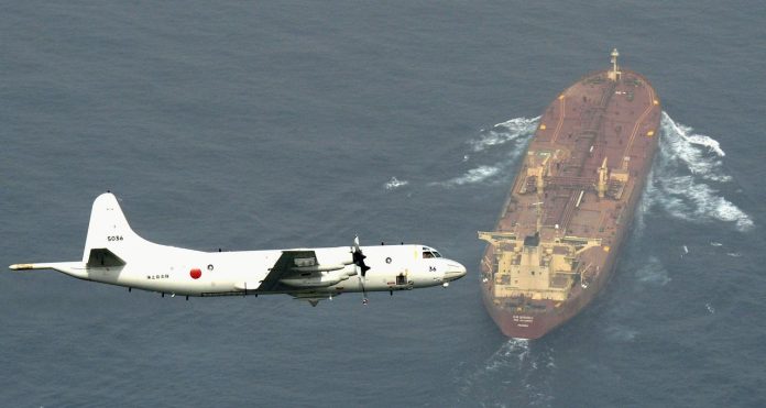 A Japan Maritime Self-Defense Force’s P3-C Orion surveillance aircraft flies over an oil tanker as the plane takes part in an anti-piracy operation at the Gulf of Aden, off Somalia, in this photo taken by Kyodo on Aug. 1, 2015. MANDATORY CREDIT KYODO/VIA REUTERS