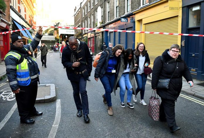 People leave the area near Borough Market after an incident at the bridge in London, Britain on Nov. 29. REUTERS/DYLAN MARTINEZ