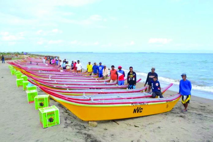 Beneficiaries of the Peter Project with their motorized fishing boats