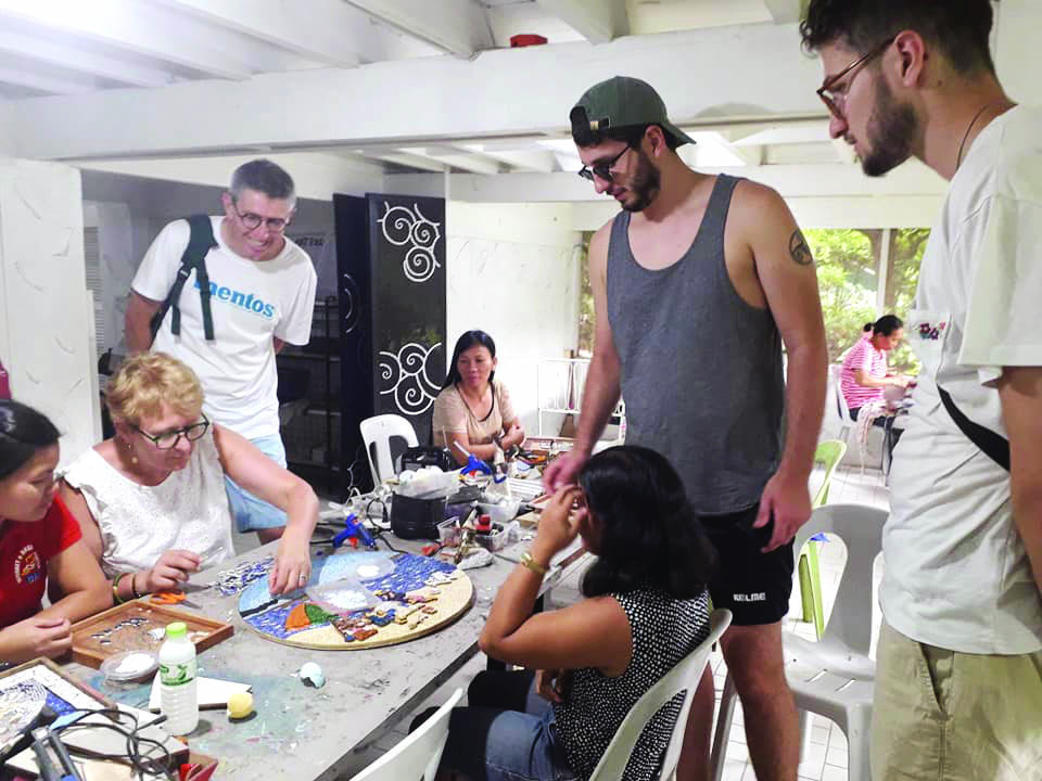 My French guests try out the mosaic