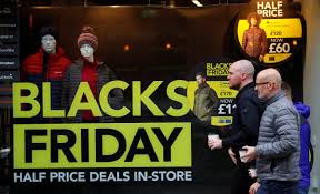 People walk past a sign advertising Black Friday offers in the window of a Blacks outdoor clothing store in Manchester, Britain Nov. 22, 2019. PHIL NOBLE/REUTERS