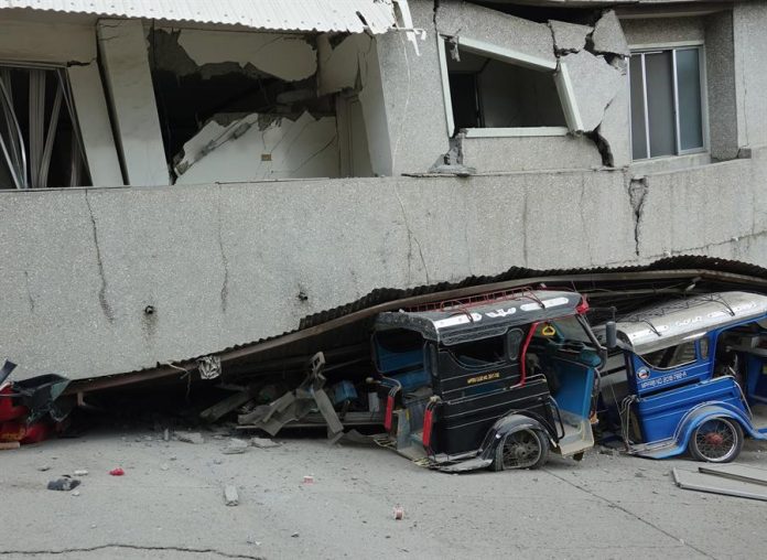 Vehicles pinned under a damaged market in the quake-hit town of Padada, Davao Del Sur on Dec. 15 . As of Monday morning, the Philippine Institute of Volcanology and Seismology recorded at least 179 aftershocks in the province.