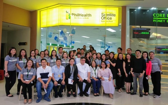 NEW OFFICE. PhilHealth officers, staff and guests pose outside the new PhilHealth Satellite Office. Sitting from left: Officer in charge for Field Operations Division Dinah Gelvezon; Pavia mayor Hon. Laurence Anthony Gorriceta; Congressman of the 2nd District of Iloilo Hon. Michael Gorriceta; acting senior manager of CorMar Nadine Navarro; senior vice president for Membership Services Sector Dr. Dennis Mas; acting regional vice president Janet Monteverde; and Robinsons Land Corporation regional operations manager Kristin September Hortelano.