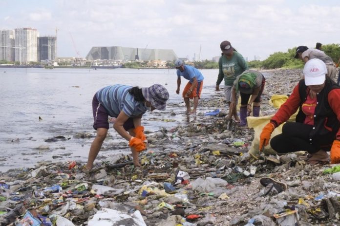 Some volunteers are seen cleaning general plastic waste along the shore. The Philippine House of Representatives is deliberating on a proposal to impose a P10 excise tax on single-use plastics. BREAK FREE FROM PLASTIC