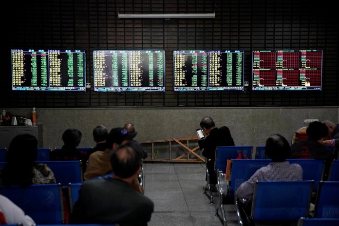 Investors look at screens showing stock information at a brokerage house in Shanghai, China. Asian shares were mostly higher Monday as jobs numbers spurred a wave of buying late last week on Wall Street. REUTERS