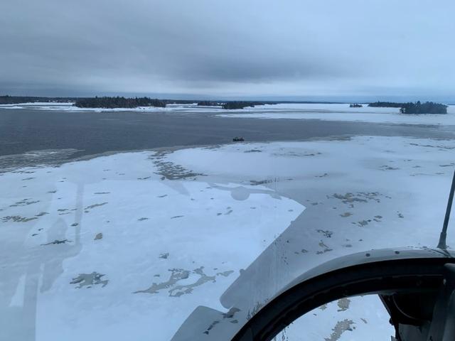 A helicopter carrying provincial police officers from the Surete du Quebec searches an area for five missing French snowmobilers off Beemer Island on Lac-St-Jean, Quebec, Canada on Jan. 22. SURETE DU QUEBEC/HANDOUT VIA REUTERS.