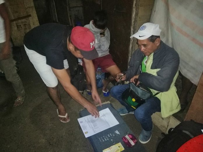 Antidrug officers inspect the items seized from Angelica Unggod during an entrapment operation in Barangay Vista Alegre, Bacolod City on Jan 5. POLICE STATION 7/BCPO