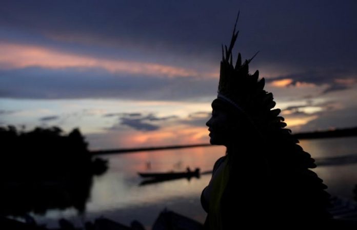 Indigenous leader of the Celia Xakriaba tribe walks next to the Xingu River during a four-day pow wow in Piaracu village, in Xingu Indigenous Park, Mato Grosso state, Brazil on Jan. 15. REUTERS/RICARDO MORAES