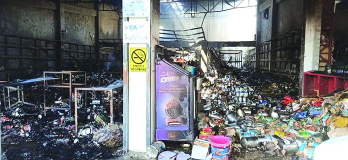 The remains of the grocery store gutted by fire in Leon, Iloilo on Jan. 12. FLO CONSUMO NAVARETE