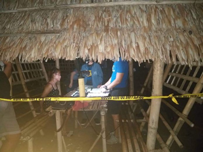 Drug suspect Hazel Joy Villavert sits handcuffed after police officers arrest her in an entrapment operation at a bar in Culasi, Antique on Jan. 16. STEPHEN LOUIE CHECA/PN