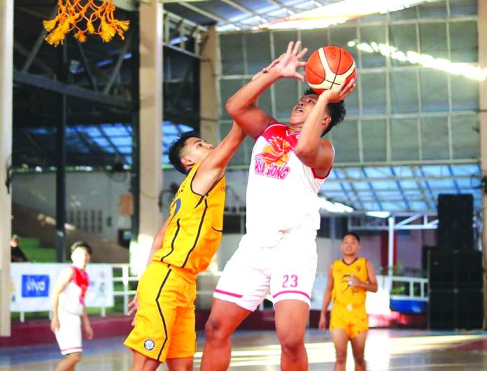 Hua Siong College of Iloilo Red Phoenix’s Reneil Gamboa scores against an Assumption School Passi City player. WINMEL LEE