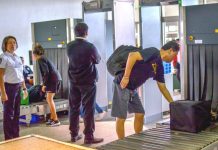 TIGHT SCREENING. As two alert airport security personnel watch, newly-arrived airline passengers pick up their baggage from conveyors after undergoing x-ray inspection at the Iloilo Airport in Cabatuan, Iloilo. The Bureau of Quarantine has deployed personnel in all airports to screen travelers as authorities try to prevent the entry of a mystery virus from China. IAN PAUL CORDERO/PN