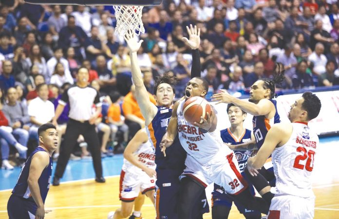 Barangay Ginebra San Miguel Kings’ Justin Brownlee attempts an inside basket amid the platoon defense from the Meralco Bolts. PBA PHOTO