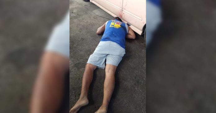 Onel Arandez, councilman of Barangay Punta Tabuc, lies lifeless on the ground after three unidentified suspects peppered him with bullets at a repair shop in Barangay Cagay, Roxas City, Capiz on Jan. 7. GLENN BEUP/PN