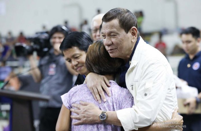 President Rodirgo Duterte leads the distribution of family food packs to the victims affected by the Taal Volcano eruption during his visit at the Batangas City Sports Coliseum on Tuesday. Duterte warned residents not to go back to their homes as Alert Level 4 remains in the 14-km danger zone. PCOO