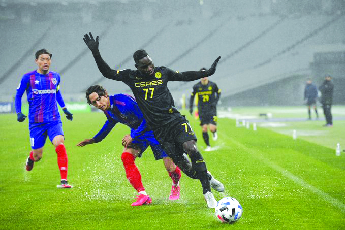 Ceres-Negros FC’s Robert Lopez Mendy shields the ball against a Japanese defender. CERES NEGROS F.C.PHOTO