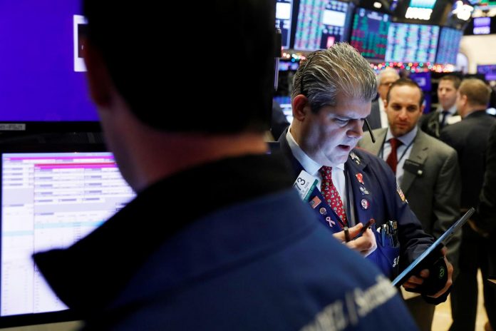 Traders work on the floor of the New York Stock Exchange shortly after the opening bell in New York, United States. World stocks on Tuesday closed out a notably profitable year, with Wall Street recording its best annual performances since 2013, boosted by hopes for a trade deal between United States and China. REUTERS