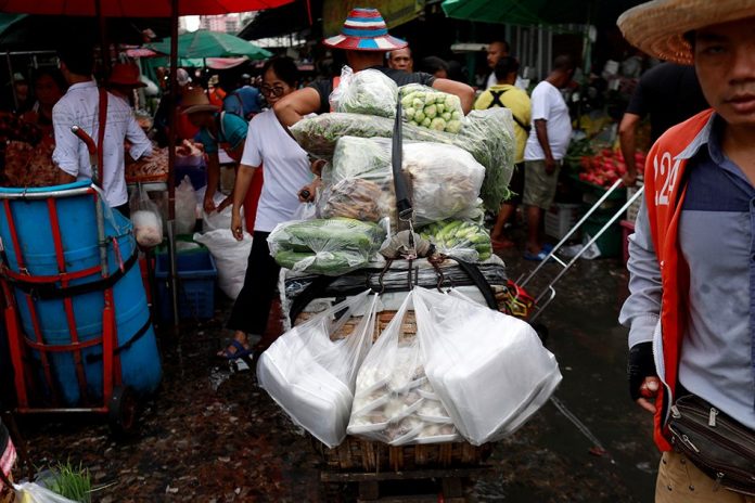 Vegetables are carried in plastics bags at a market in Bangkok, Thailand. REUTERS