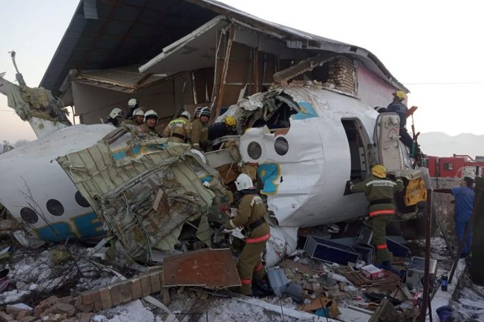 Emergency and security personnel are seen at the site of the plane crash near Almaty, Kazakhstan, Dec. 27, 2019. REUTERS