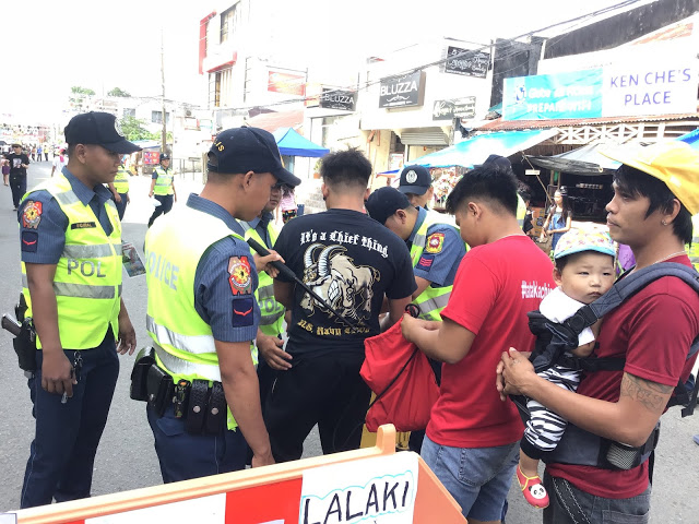 Police officers inspect the belongings of merrymakers. Kalibo chief of police Lieutenant Colonel Richard Mepania said around 1,700 police officers were deployed to secure the Ati-Atihan Festival on Jan. 10 to 19. AKEAN FORUM