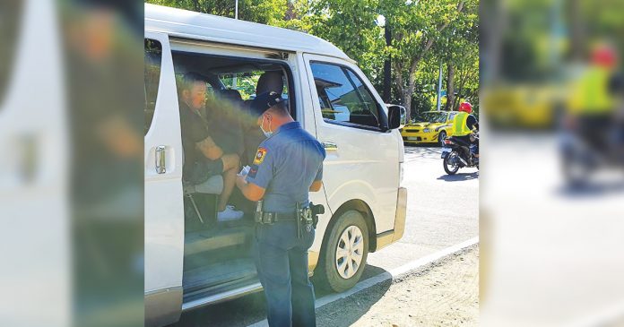 Personnel of the Malay municipal police station flag down this vehicle at a border control checkpoint here. The local government unit put up checkpoints in the boundaries of the town to lessen the risk of spreading the corona virus disease 2019 (COVID-19). MALAY AKLAN PNP