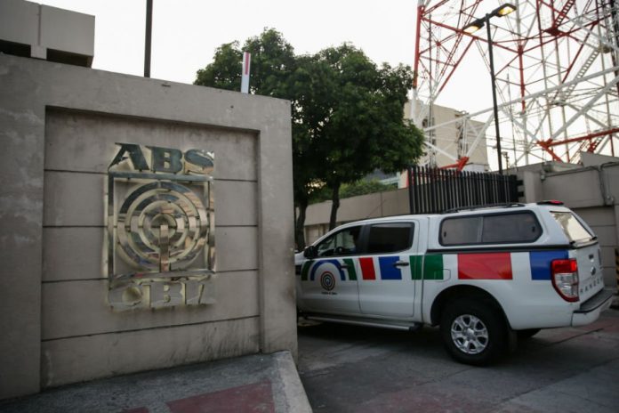 A media crew cab enters the ABS-CBN Broadcasting Center, the office of the country's top broadcast network, following a move by the Philippine government to scrap its franchises, in Quezon City, Feb. 10, 2020. Reuters