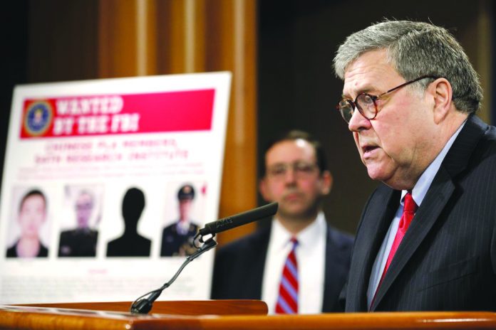 Attorney General William Barr speaks during a news conference, Monday, Feb. 10, 2020, at the Justice Department in Washington, as Principal Associate Deputy Attorney General Seth Ducharm looks on. AP