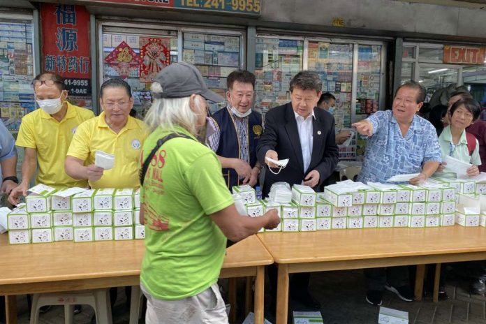 Members of the Federation of Filipino Chinese Chambers of Commerce and Industries Incorporated (FFCCCII) give out free face masks to passersby at the Binondo District in Manila, Thursday. ABS-CBN NEWS