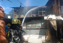 Firemen spray with water this house that fire struck in Barangay Tanza Esperanza, Iloilo City on Sunday, Feb. 23. The fire gutted a total of eight houses , four of which were totally destroyed. IAN PAUL CORDERO/PN